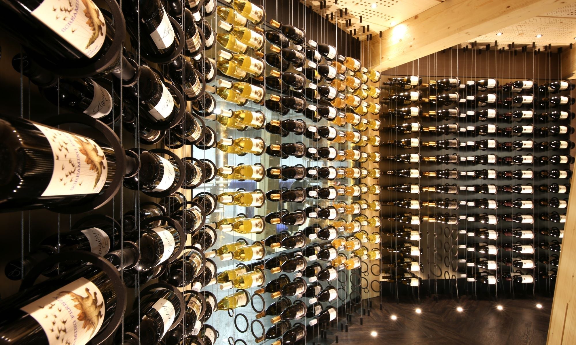 Modern metal wine racks with assorted bottles in a custom cellar display