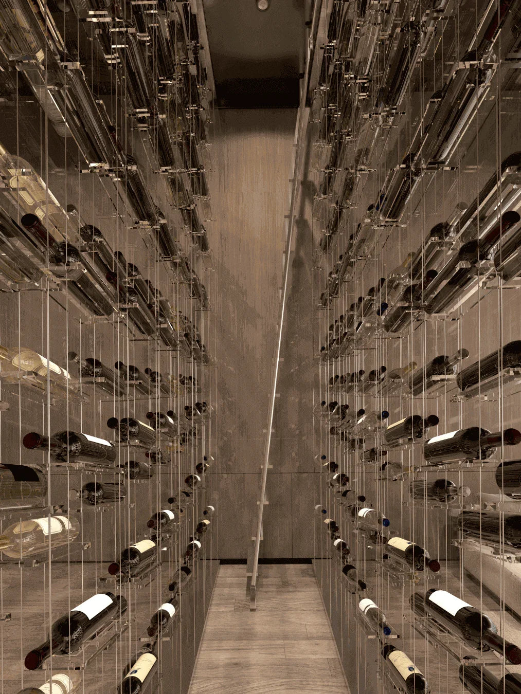 Lumina cable wine display showcasing vertical storage density with precision-milled aluminum hardware. This floating rack system highlights the secure, contemporary storage of wine bottles using a high-strength tension cable kit