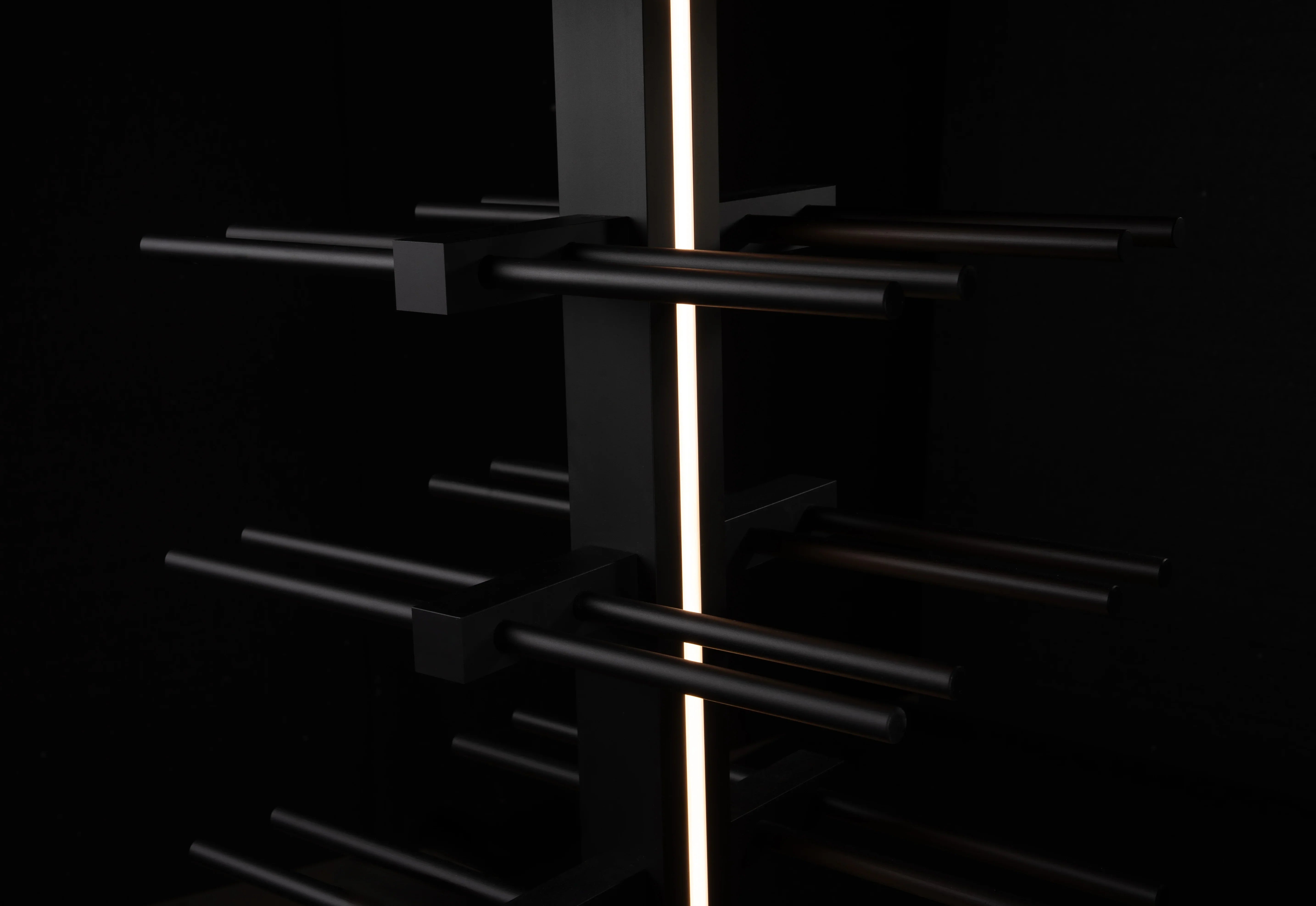 Black metal frame with a central light source on a black background