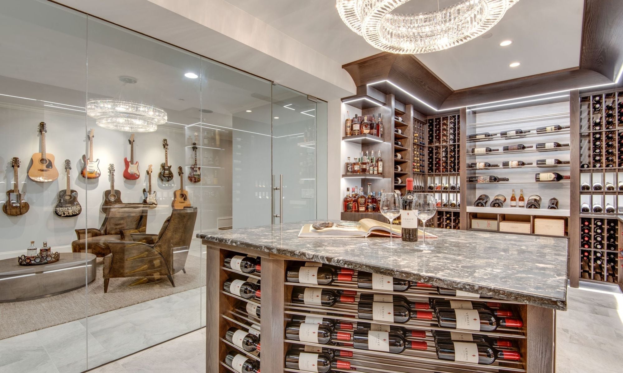 Modern glass-enclosed wine cellar with luxury racks, marble countertop, and backlit shelving.