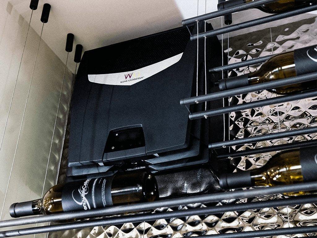 Modern wine cellar cooling unit with metal wine racks and bottles, reflective wall surface