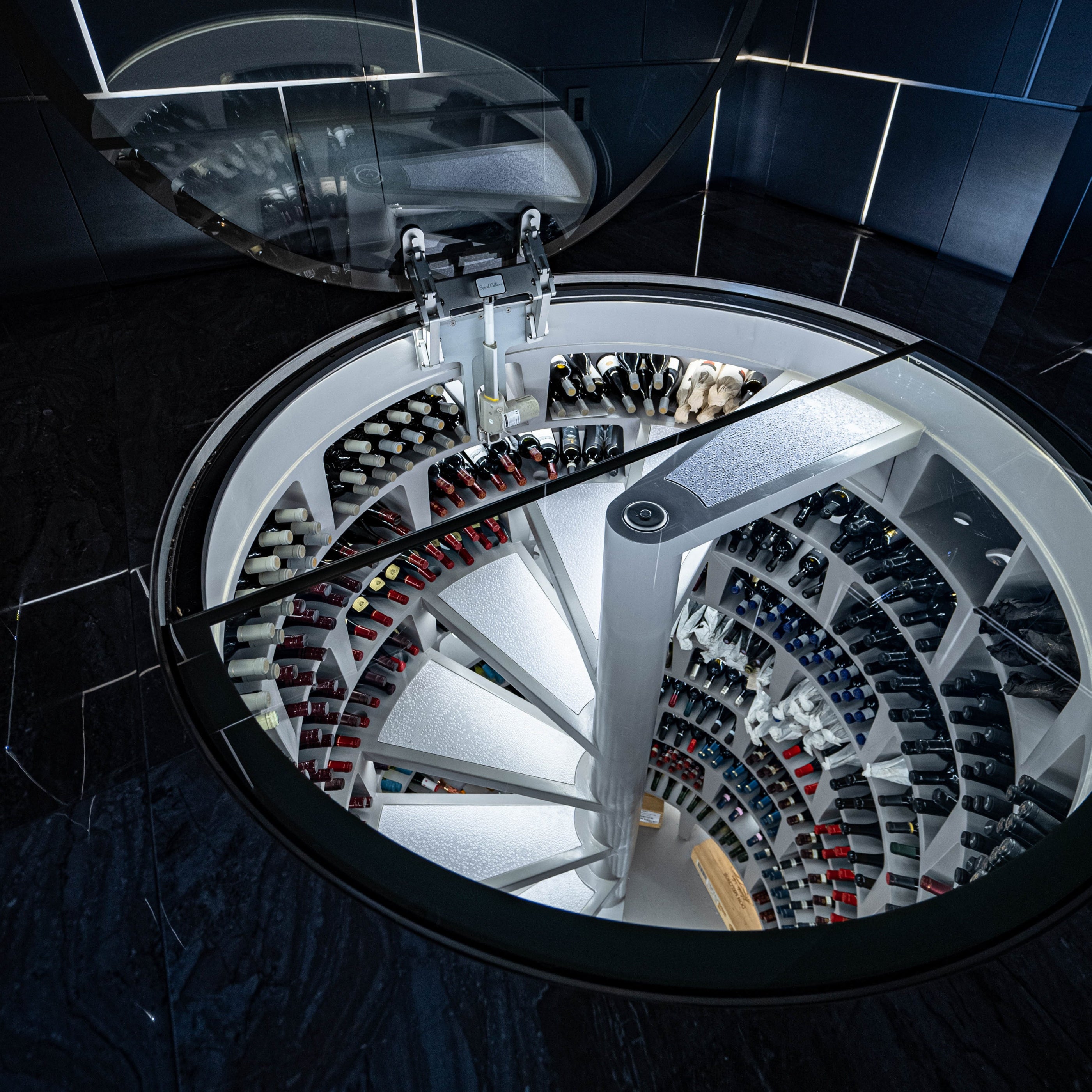 Spiral staircase with wine bottles arranged in a circular pattern