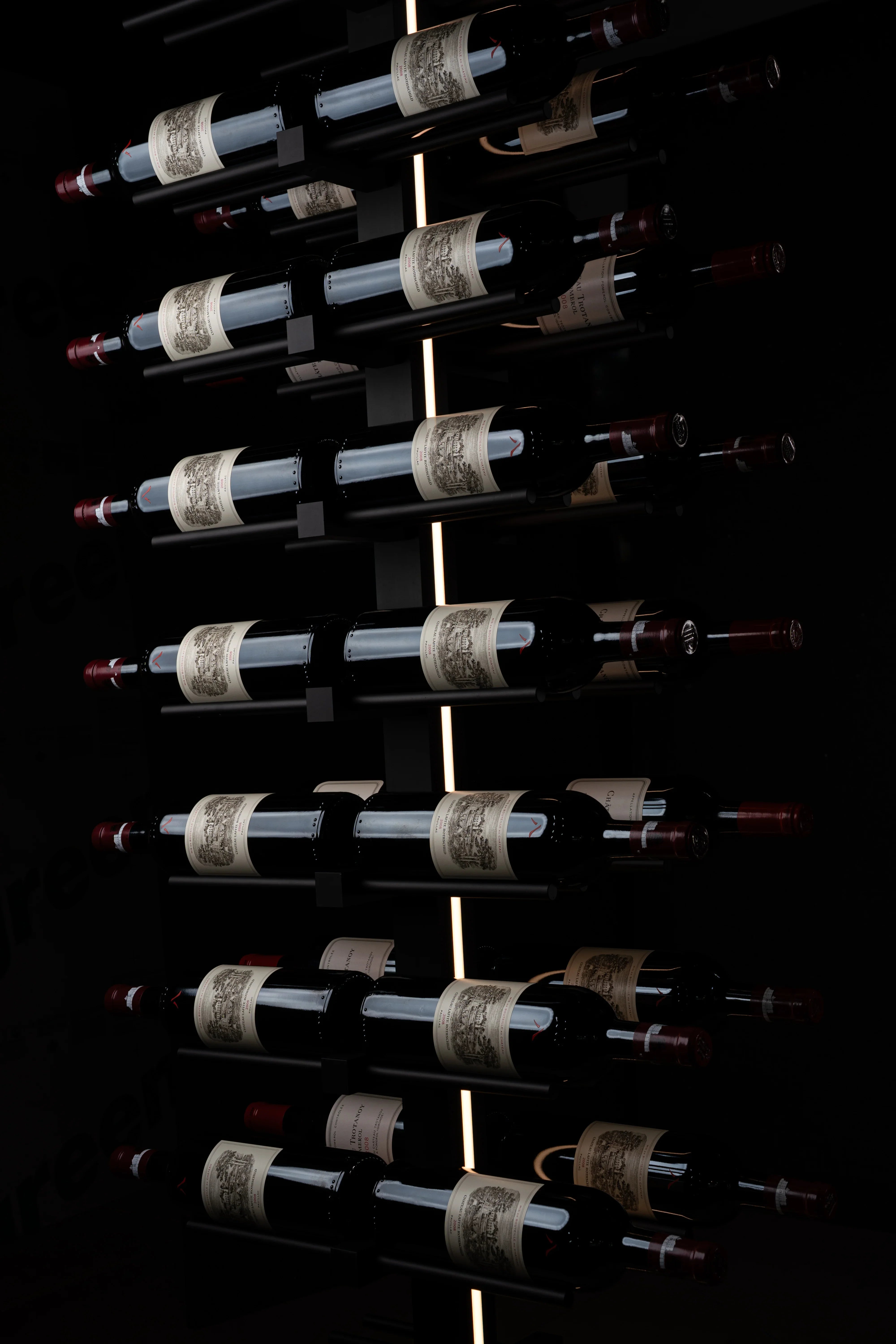 Wine bottles arranged vertically on a dark background
