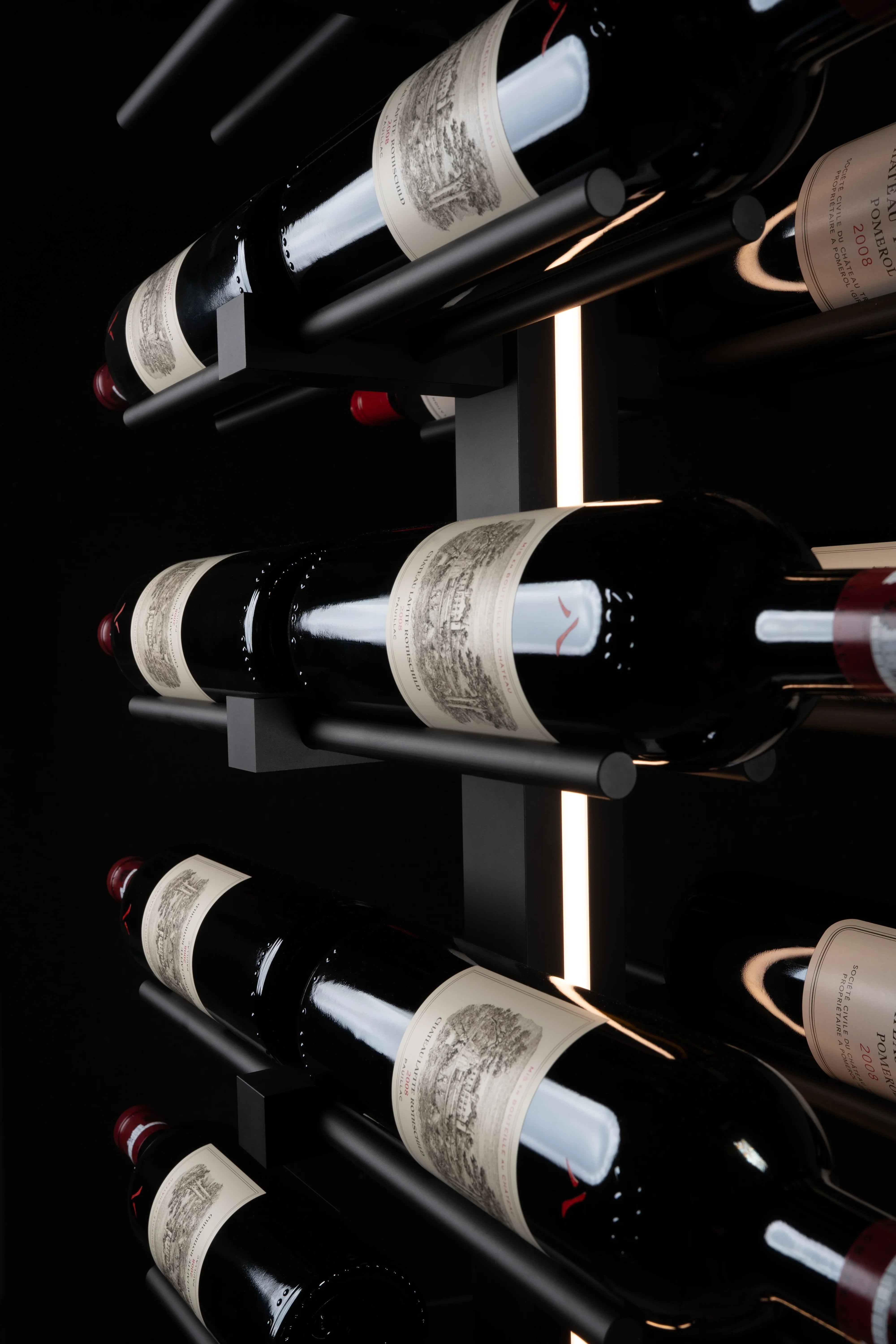 Wine bottles arranged on a black wine rack against a dark background